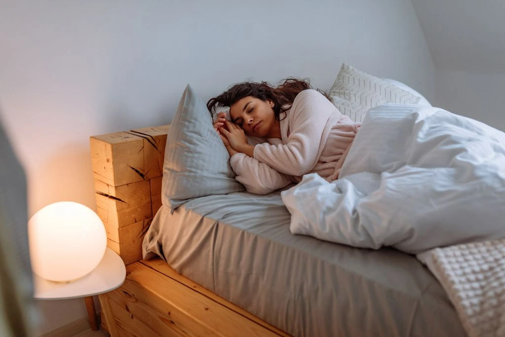 A woman sleeping soundly in her bed