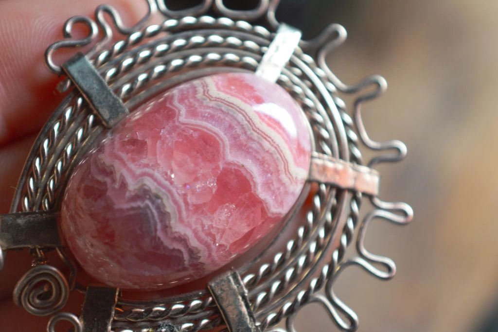 Person holding Rhodochrosite Gemstone collection