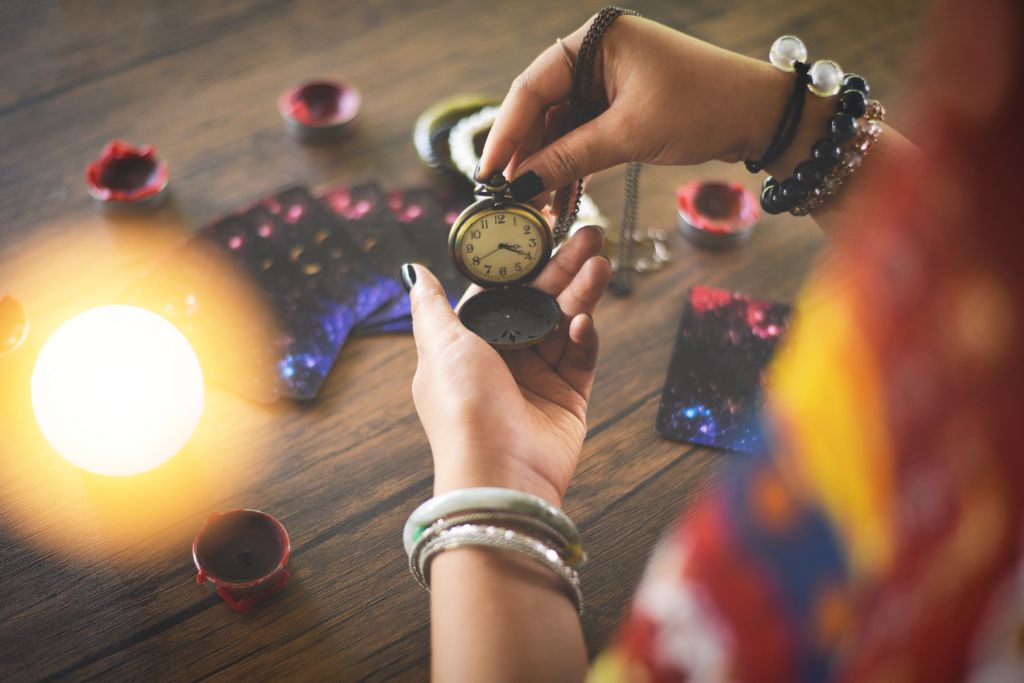 A person holding a watch doing psychic reading and clairvoyance