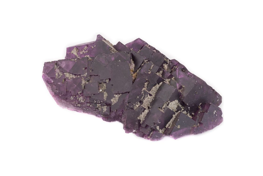 Purple fluorite crystal on a white background