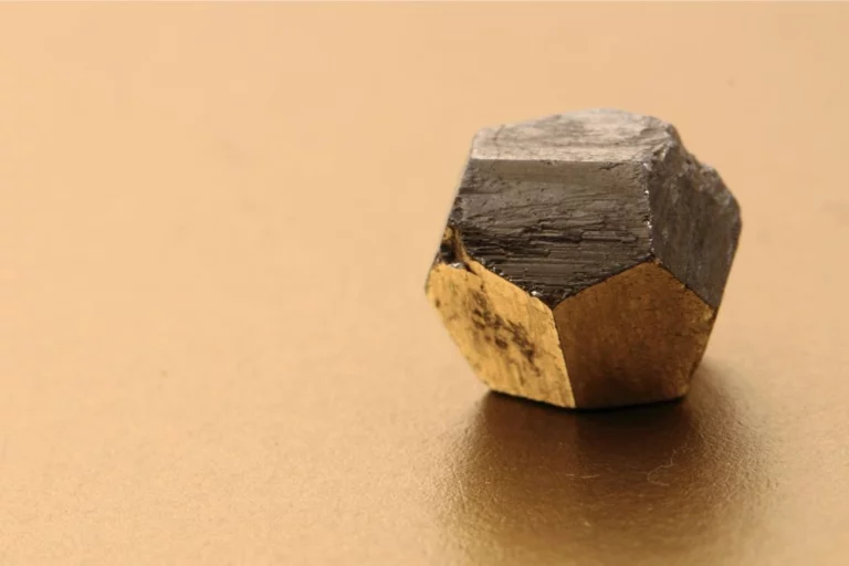Pyrite crystal on a goldish background