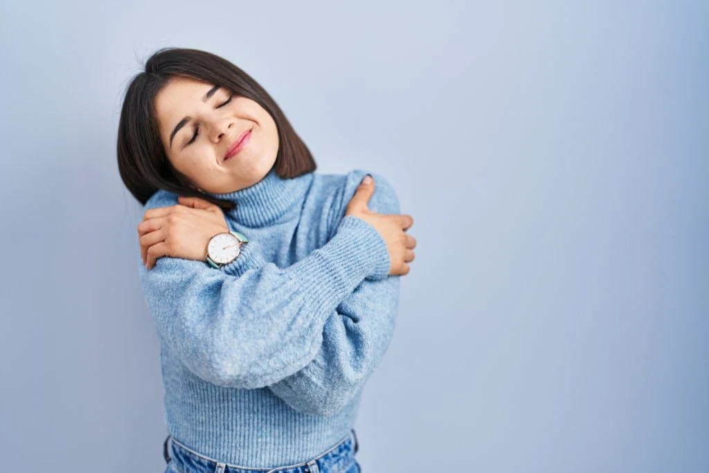 A woman hugging herself