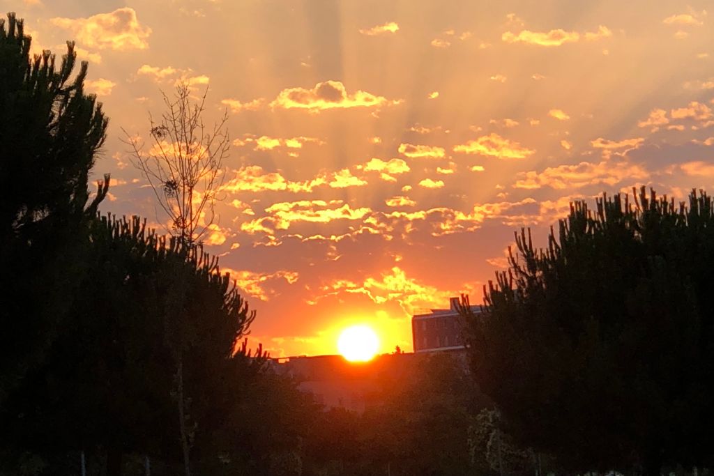 The sun is rising over a house