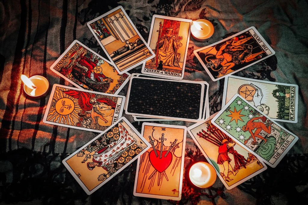 tarot cards and candles on a piece of cloth