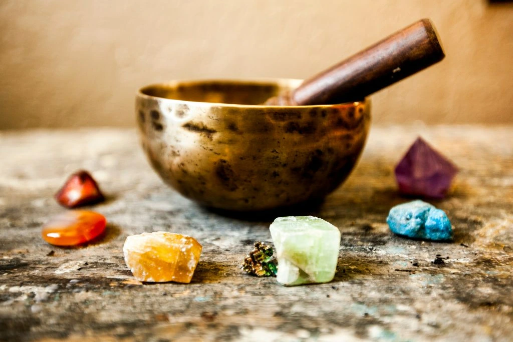 Tibetan singing bowl surrounded by gemstones