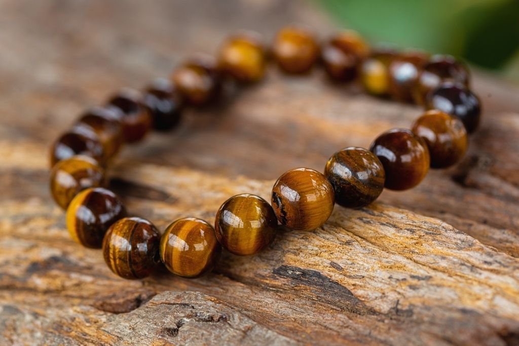 Tigers eye crystal bracelet placed on a wooden platform