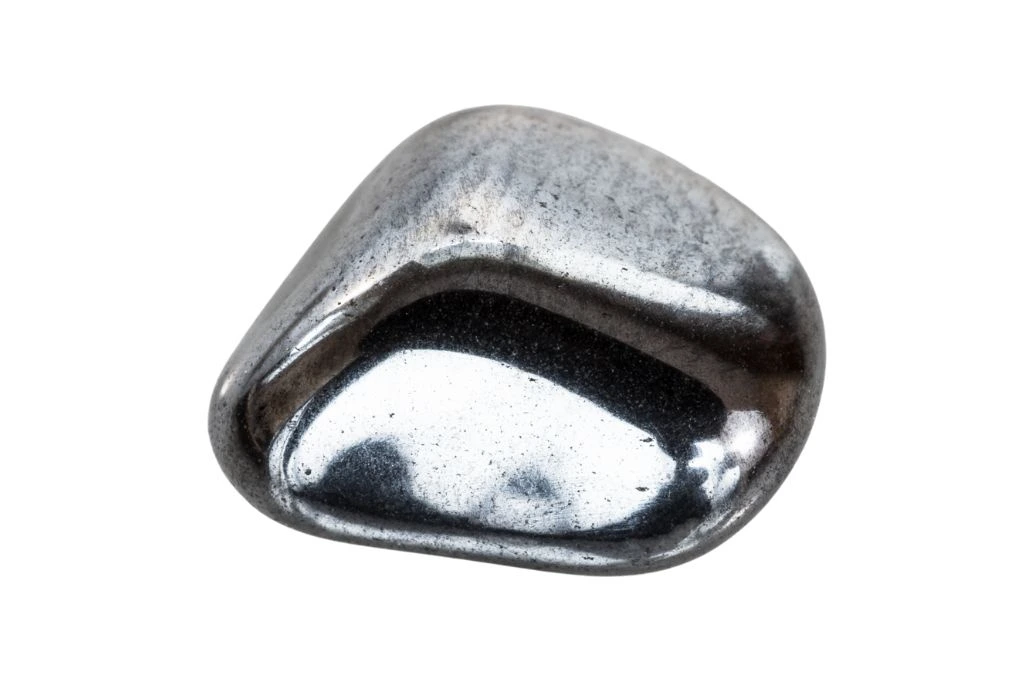 A tumbled hematite crystal on a white background
