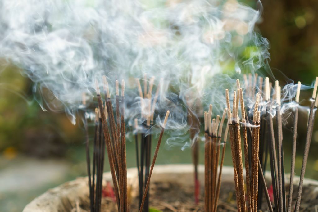 Incense sticks that is burning with the smoke is rising