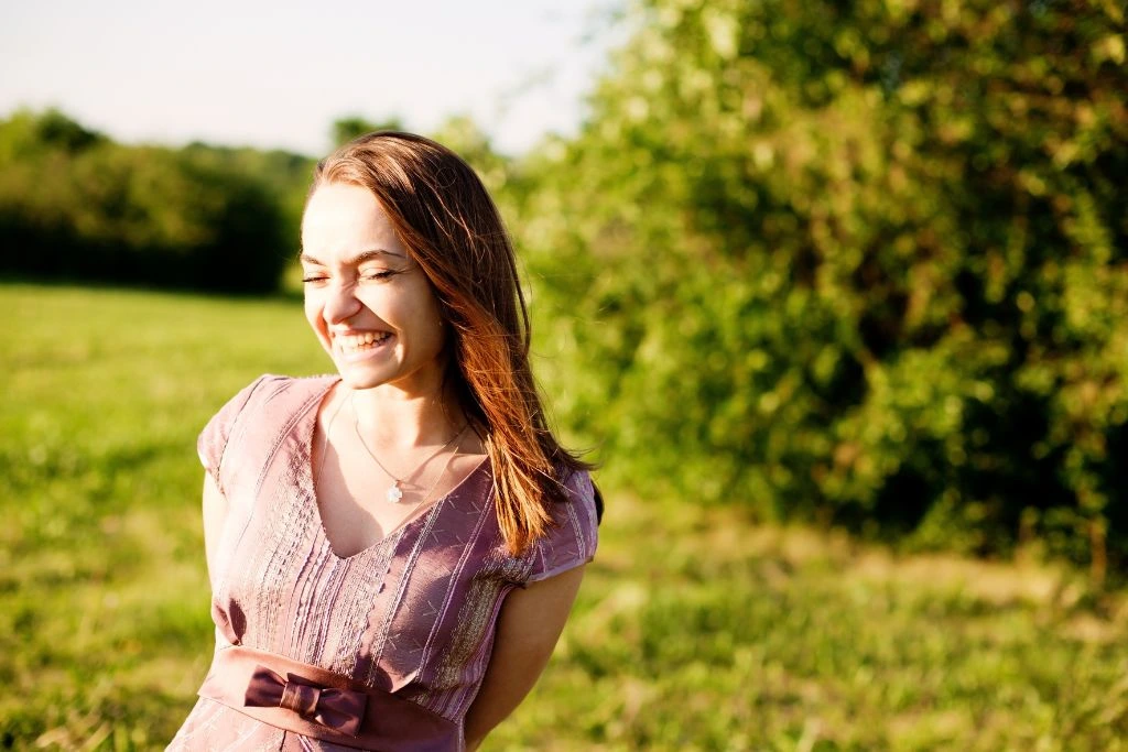 A woman smiling in nature