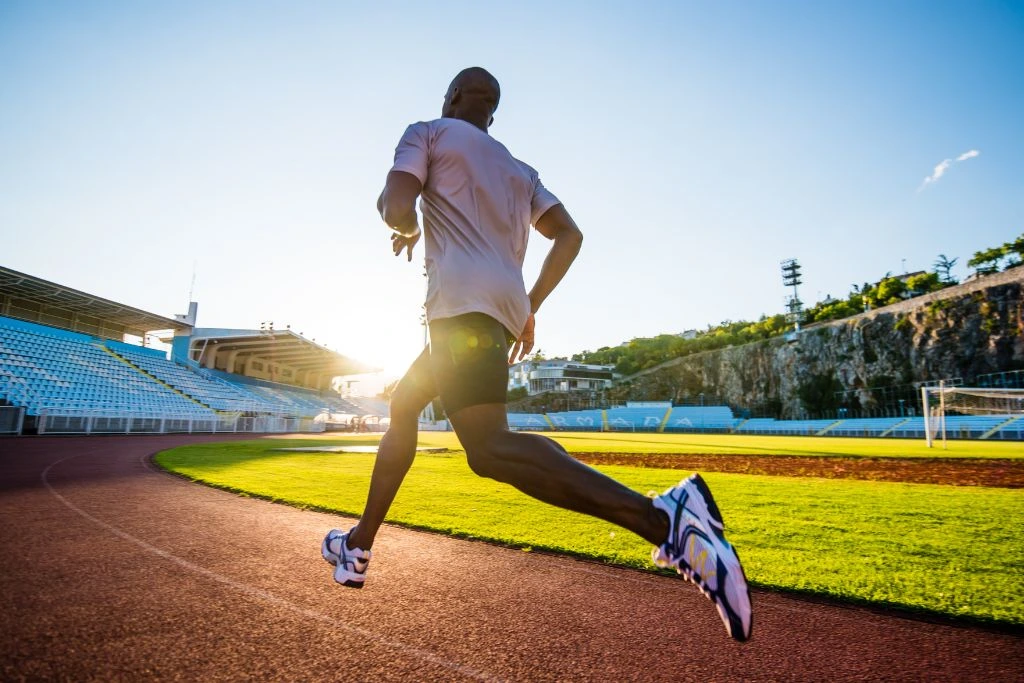 a man running on a track and field course