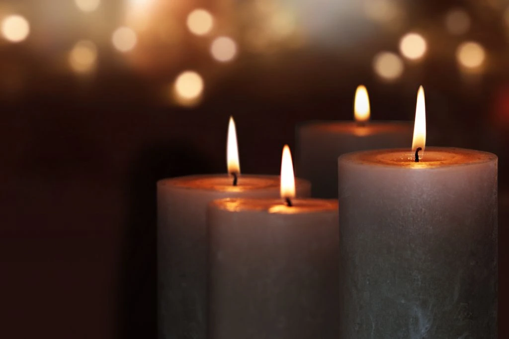 lighted candles on a dark background