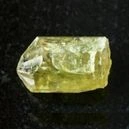 golden yellow apatite o a black background