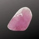 a kunzite crystal on a dark background