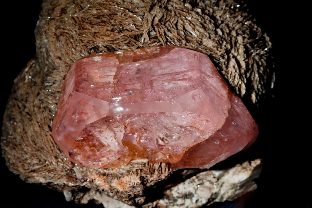 A morganite crystal on a dark background