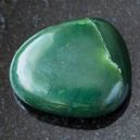 A nephrite crystal on a black granite