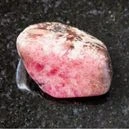 rhodonite crystal on a graphite tile