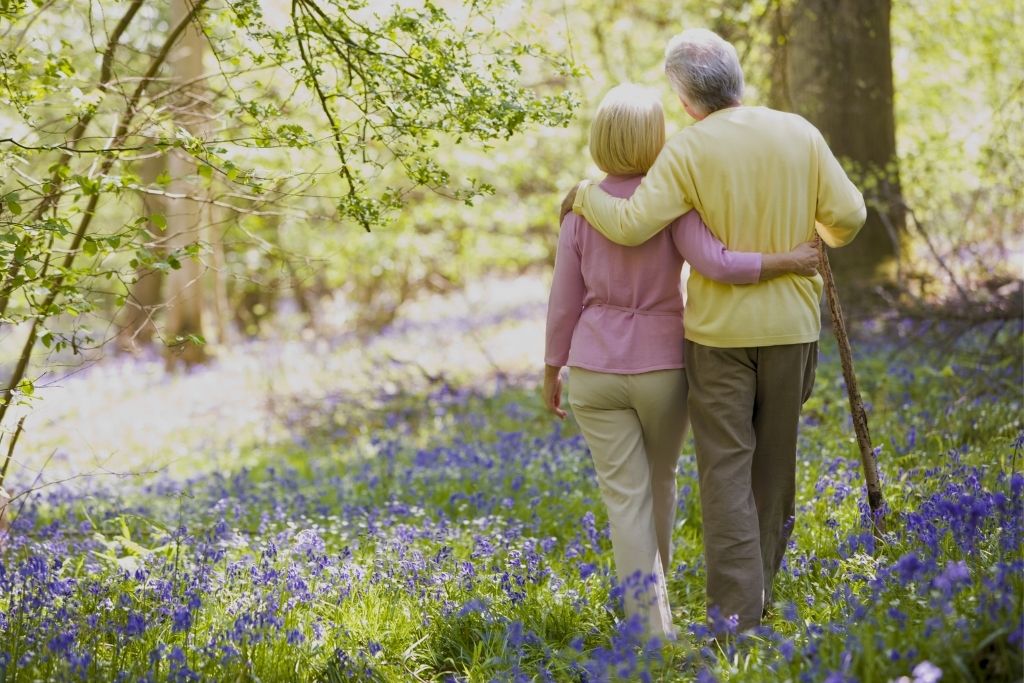 senior couple enjoying the nature while showing physical affection to each other