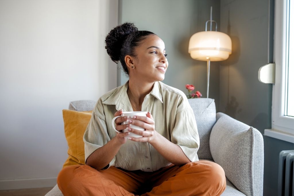 woman drinking coffee and in good mental wellbeing