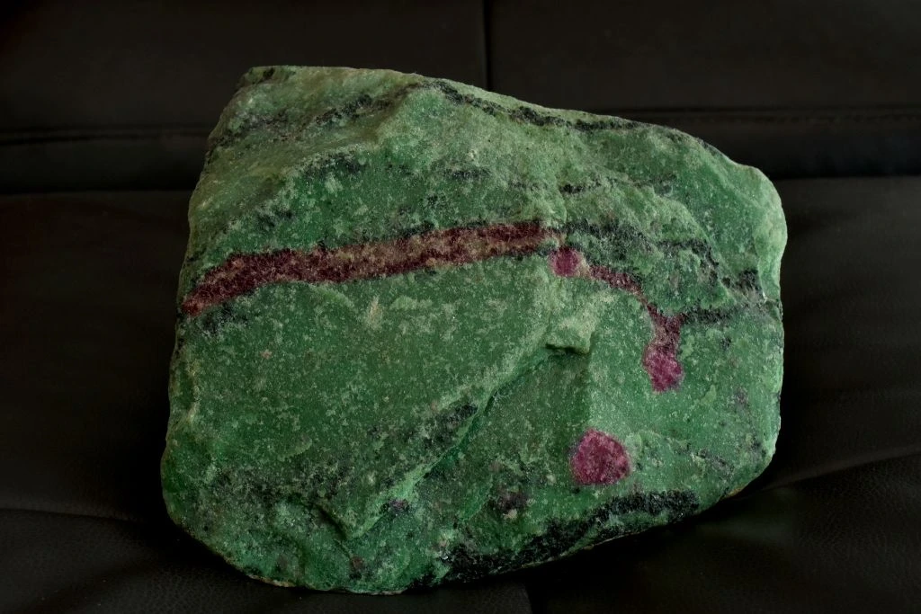 A zoisite crystal on a leather seat