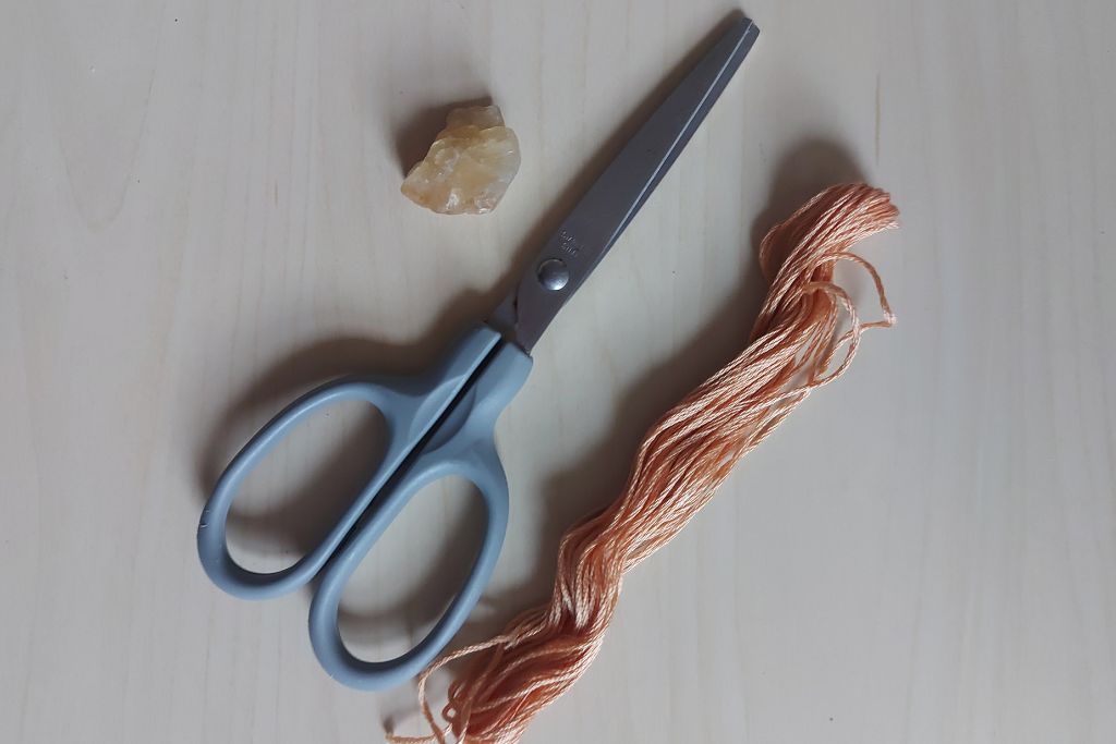 pair of string, citrine and scissor for making a crystal necklace