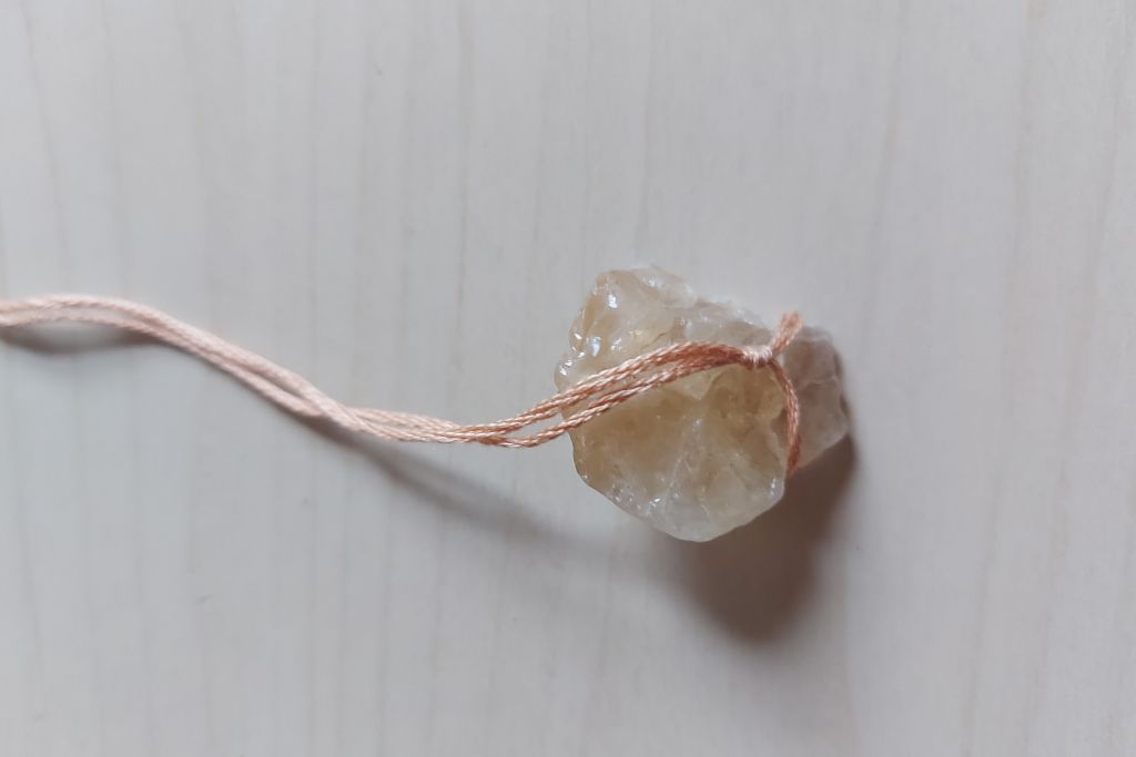 string attached to crystals bottom part