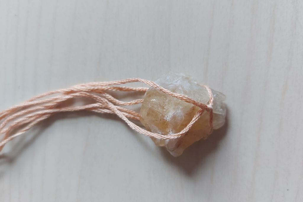 string net hooked at the bottom part of citrine