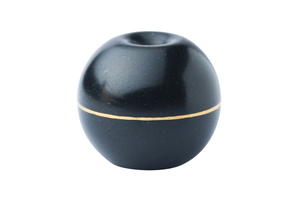 A black agate pharmacy bead on a white background