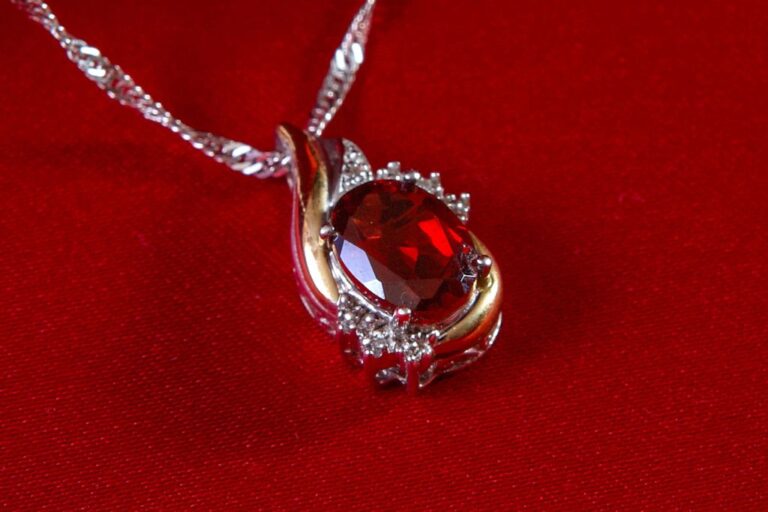 A ruby necklace on a red cloth