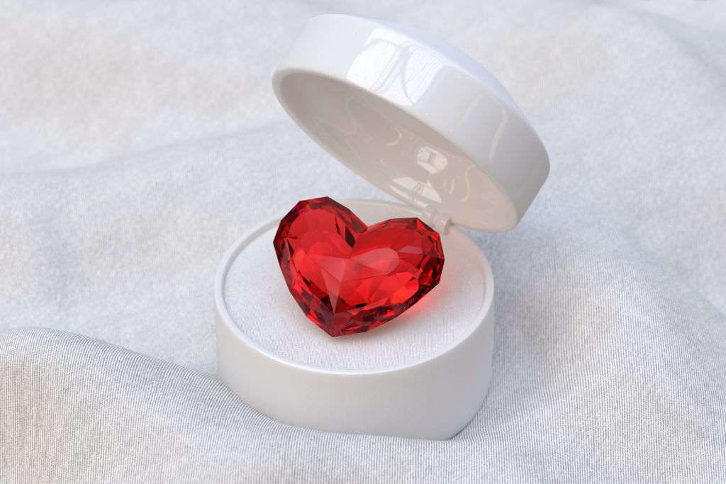 A polished ruby crystal on a jewelry box