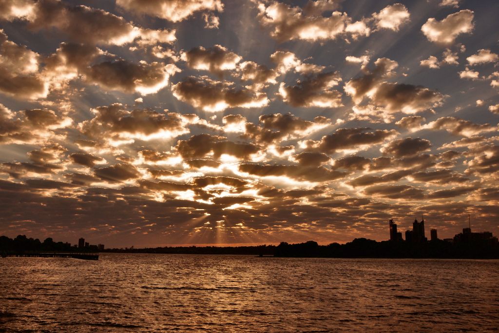 A silhouette of a town from the sea