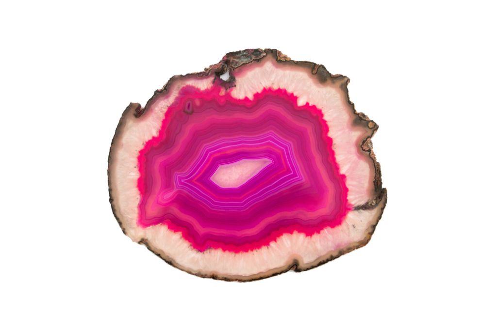 A slice of pink agate crystal on a white background