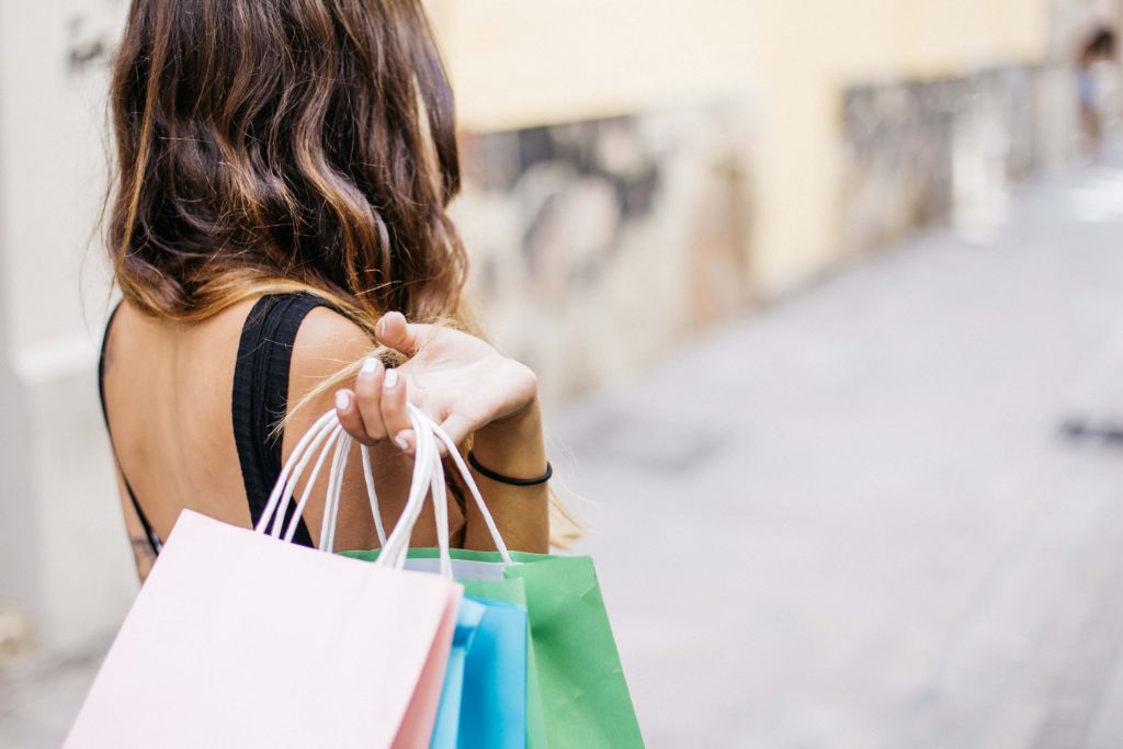 A woman is holding multiple shopping bags