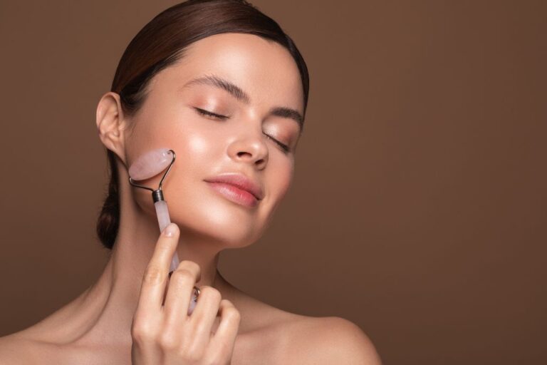 A woman is using a crystal face roller on her face