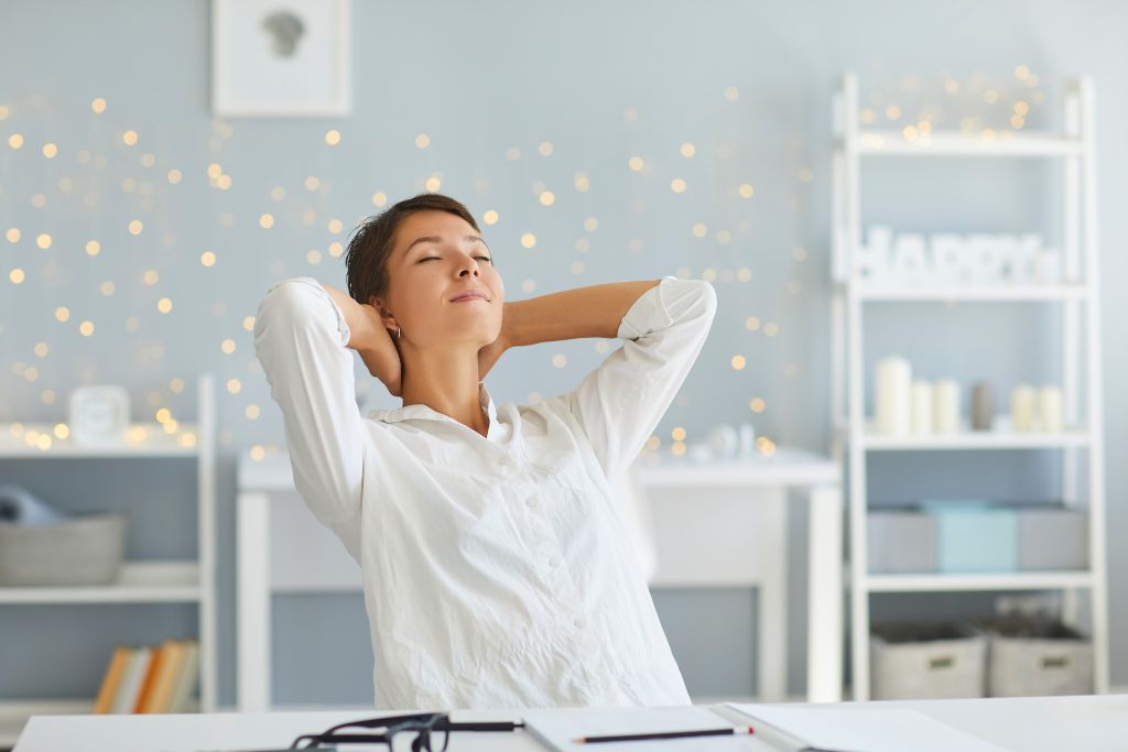 A woman is sitting in a room and smiling