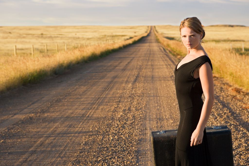 A woman standing on the middle of the road