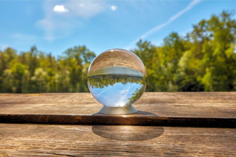 crystal ball in an outdoor environment with green and blue scenery background