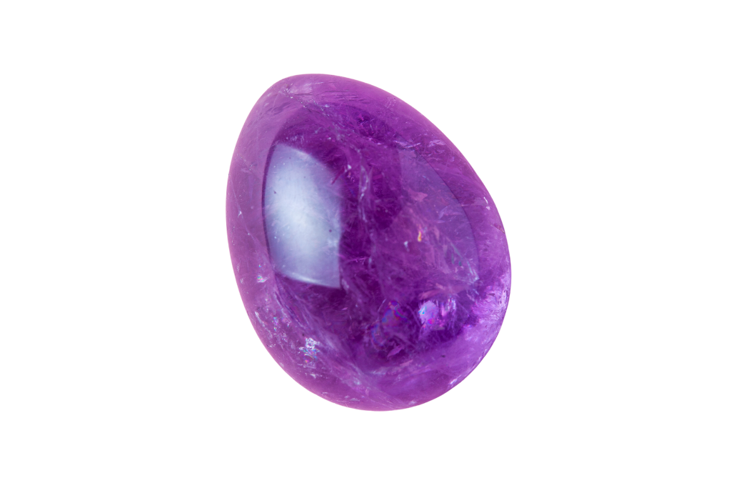 An Amethyst yoni egg on a white background