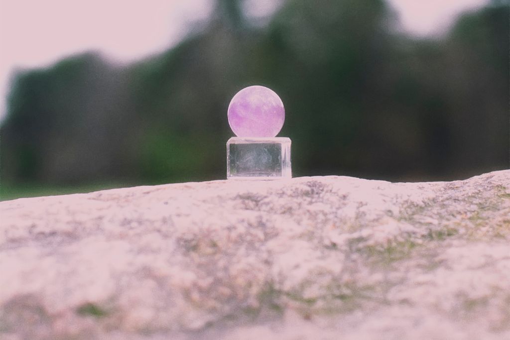 An Amethyst Crystal ball on a pedestal