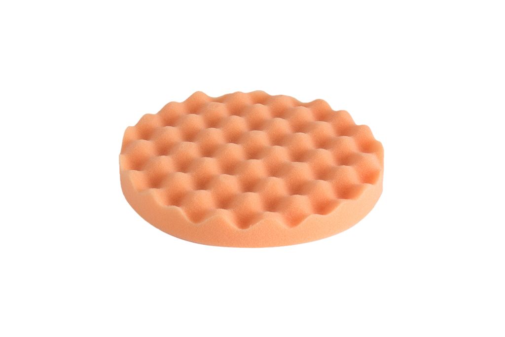 An orange polishing wheel on a white background