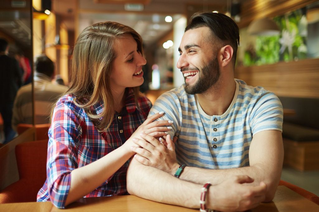 A man and woman smiling at each other