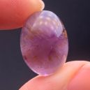 A person holding a small polished Auralite 23 crystal. Source: Etsy | FamilyOfCrystal