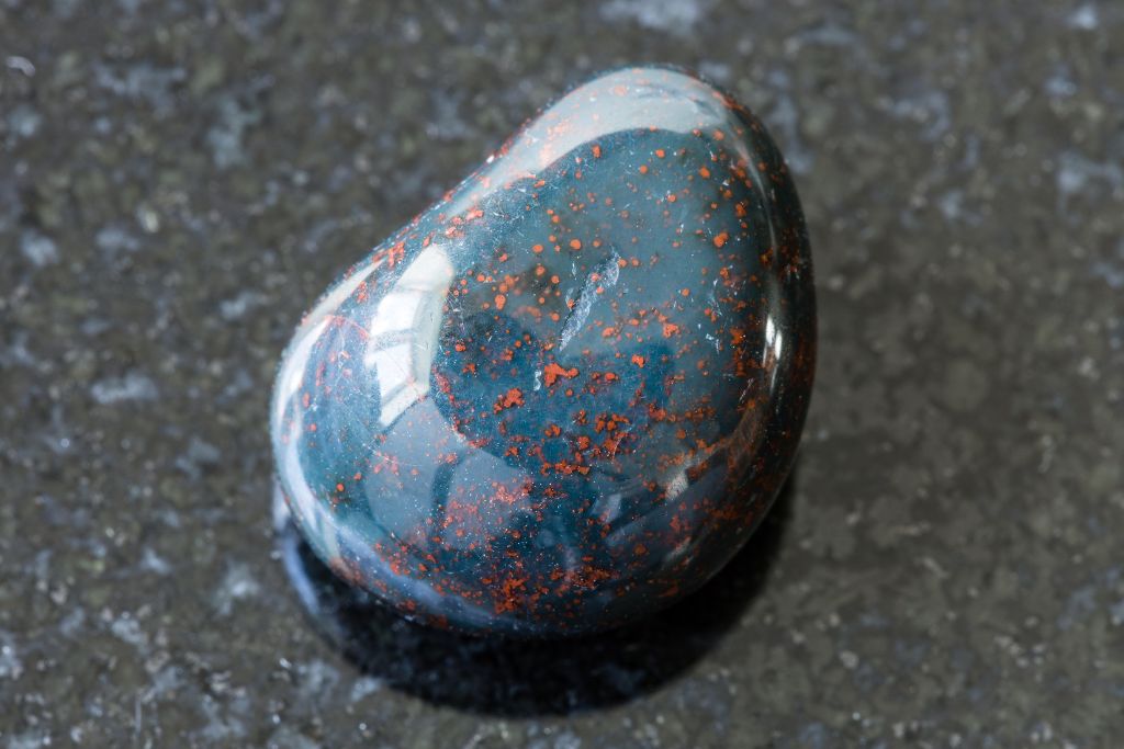 A bloodstone on a black granite background