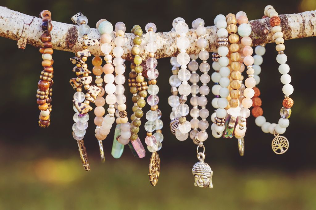 Different kinds of bracelets hanging on a tree branch