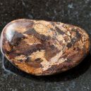 A bronzite on a black granite background