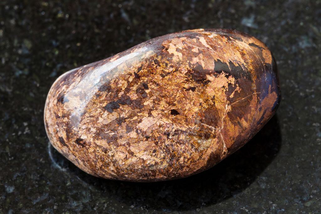 A Bronzite crystal on a granite background