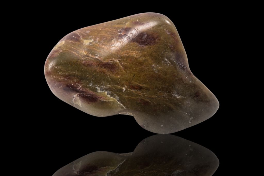 A Brown Jasper on a black reflective background