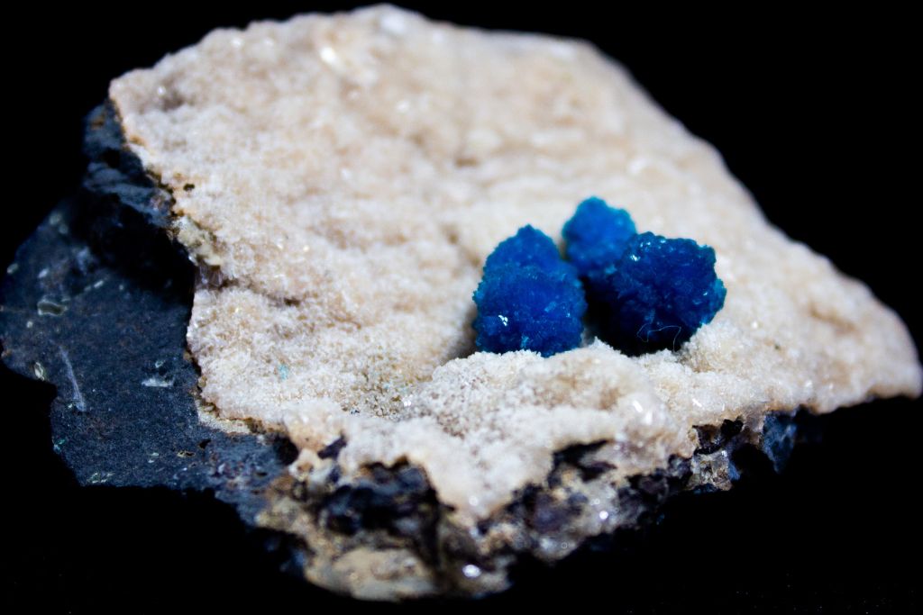 A cavansite crystal on a black background