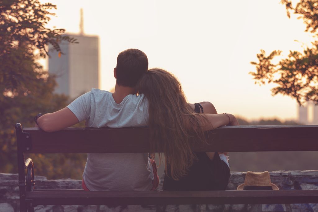 A couple sitting together on the bench