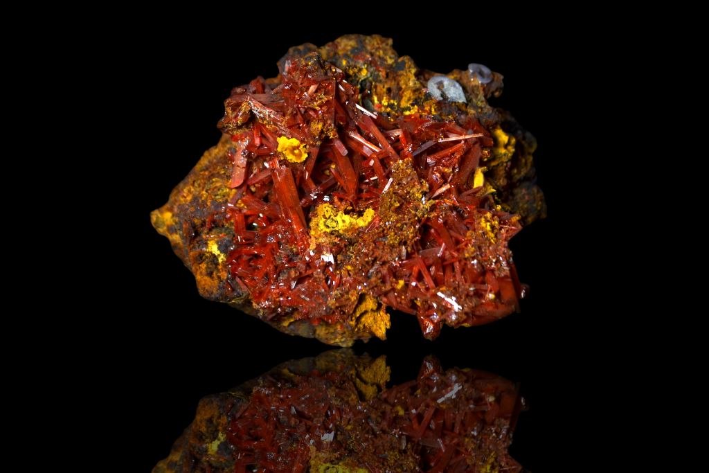 Crocoite crystal on a black reflective background