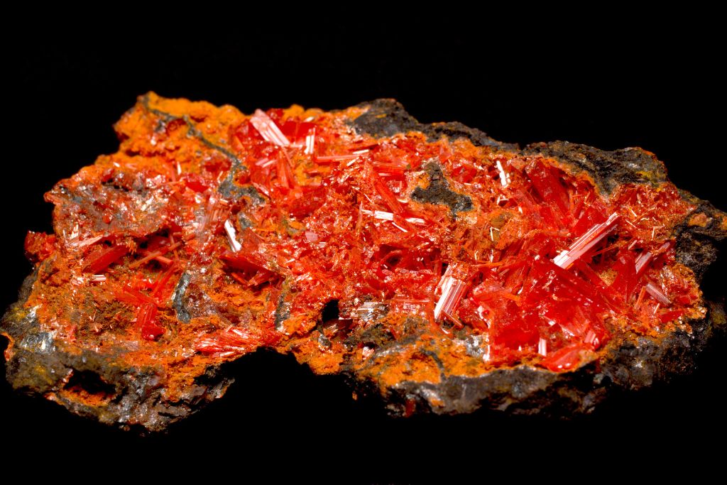 A crocoite crystal on a black background